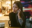 woman talking on phone outdoor in front of store