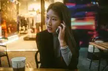 woman talking on phone outdoor in front of store